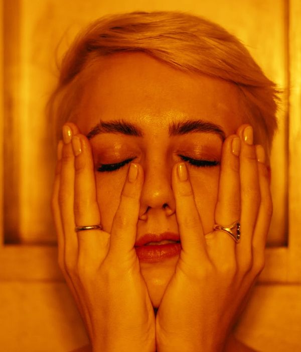 Serene woman with closed eyes, feeling relaxed.